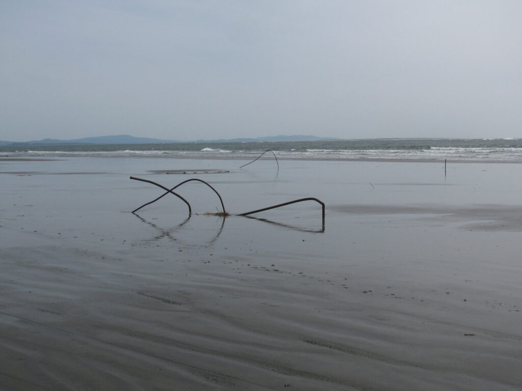 pipes in sand from wash away beach